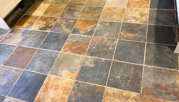 Riven slate floor showing texture that needs finish recovery rather than polishing