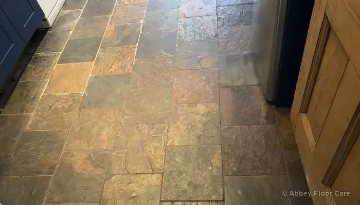 Dull slate floor in Renfrewshire with flat colour and worn traffic areas