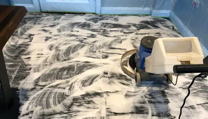 Old sealer and coating being stripped from a slate floor